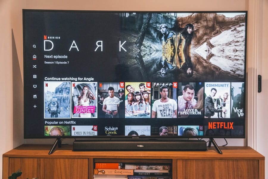 A living-room TV on a wooden console displays the Netflix home screen with the series “Dark” highlighted and rows of recommended shows below.