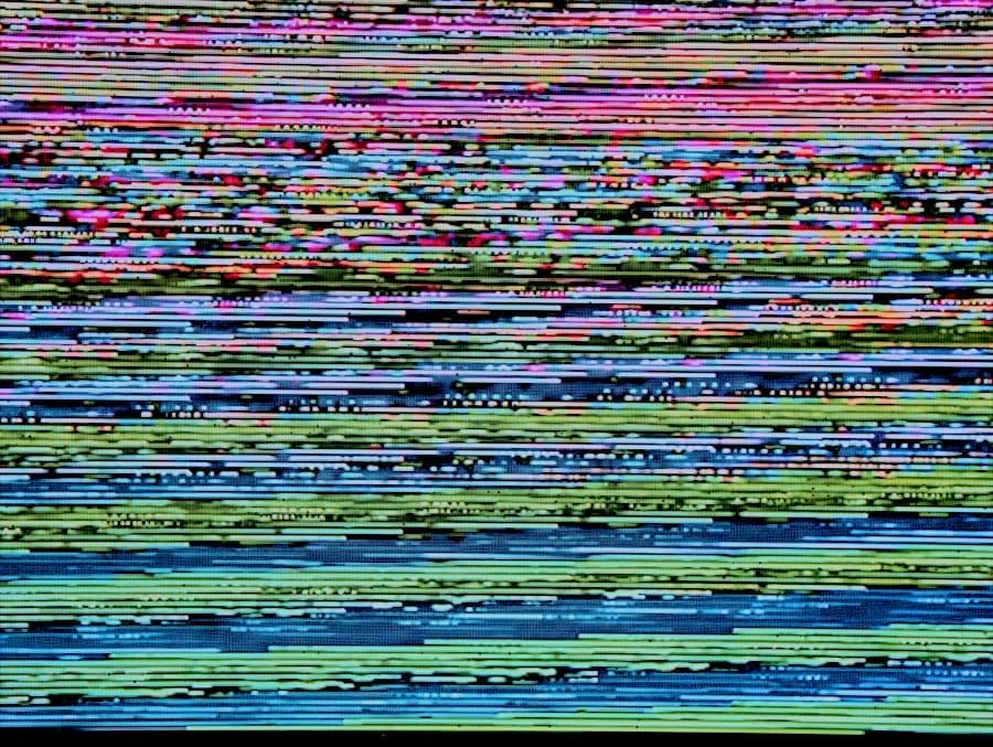 Multicolored horizontal glitch lines and pixel noise across a screen, resembling TV signal interference.