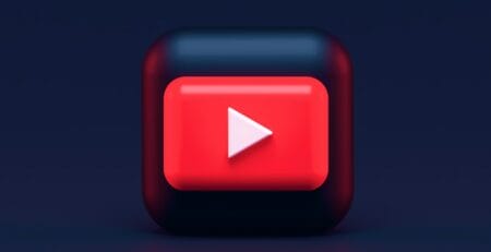 3D red play button with a white triangle on a rounded dark square, resembling the YouTube logo, against a dark gradient background.